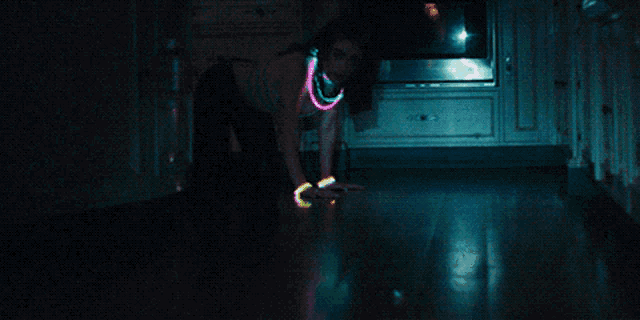 a woman wearing glow in the dark necklaces and bracelets