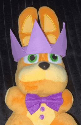 a stuffed bunny wearing a purple crown and a purple bow tie