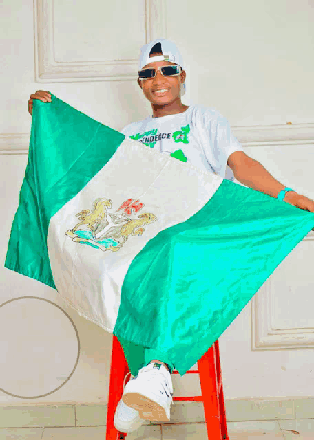 a boy holding a flag that says ' independence ' on it