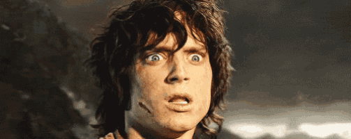 a close up of a man 's face with a surprised expression .