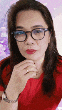 a woman wearing glasses and a red shirt