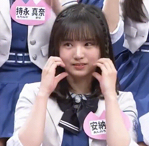 a girl wearing a name tag with chinese writing on it
