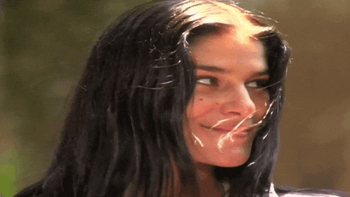 a close up of a woman 's face with a slight smile on her face
