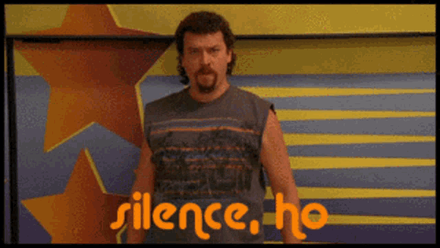 a man stands in front of a wall that says silence