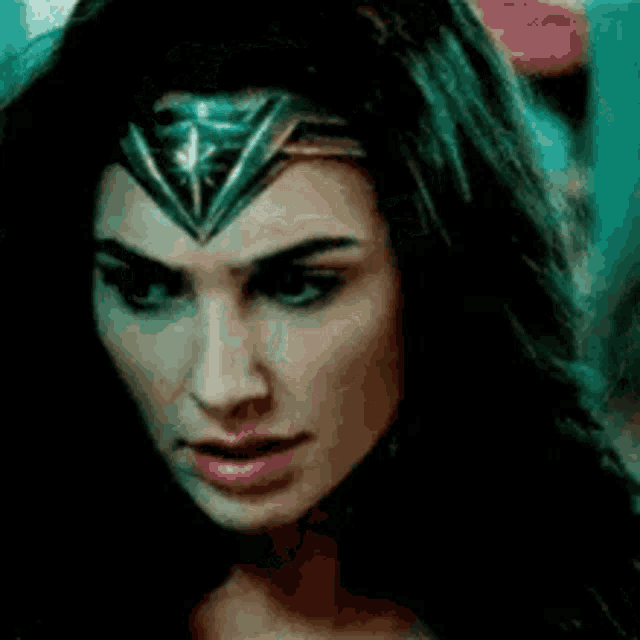 a close up of a woman 's face wearing a crown .