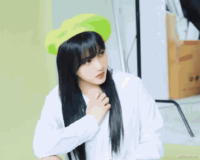 a woman wearing a green beret and a white shirt with the word bitsowon on the bottom right