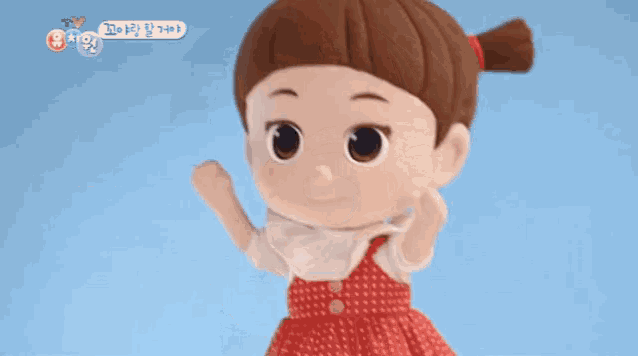 a stuffed doll with a ponytail is standing in front of a blue background with korean writing on it