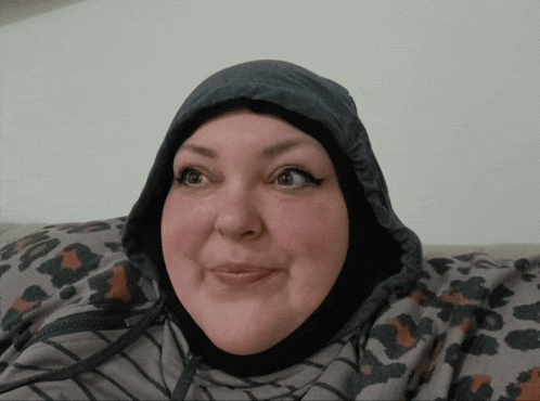 a woman wearing a hooded jacket with a leopard print on it