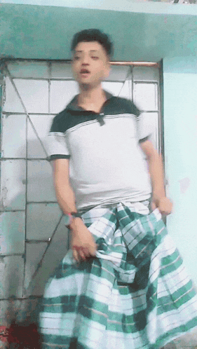 a man wearing a green and white plaid skirt