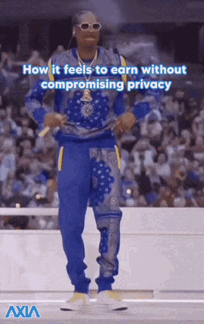 a man in a blue outfit is dancing in front of a crowd with the words how it feels to earn without compromising privacy