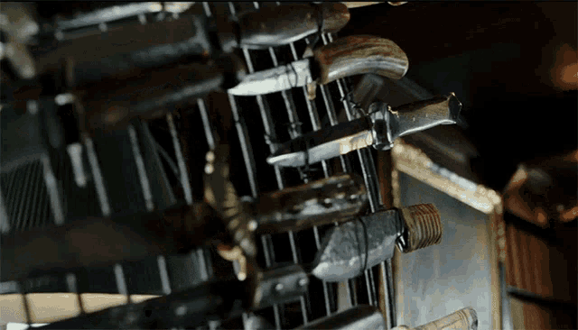 a bunch of knives are hanging on a shelf