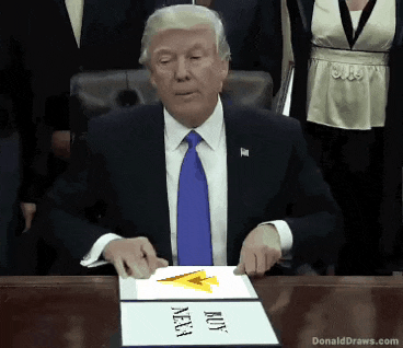 donald trump is sitting at a table with a sign that says buy nasa