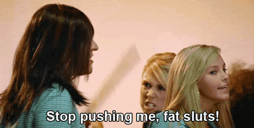 a group of women are standing next to each other and one of them says stop pushing me fat sluts