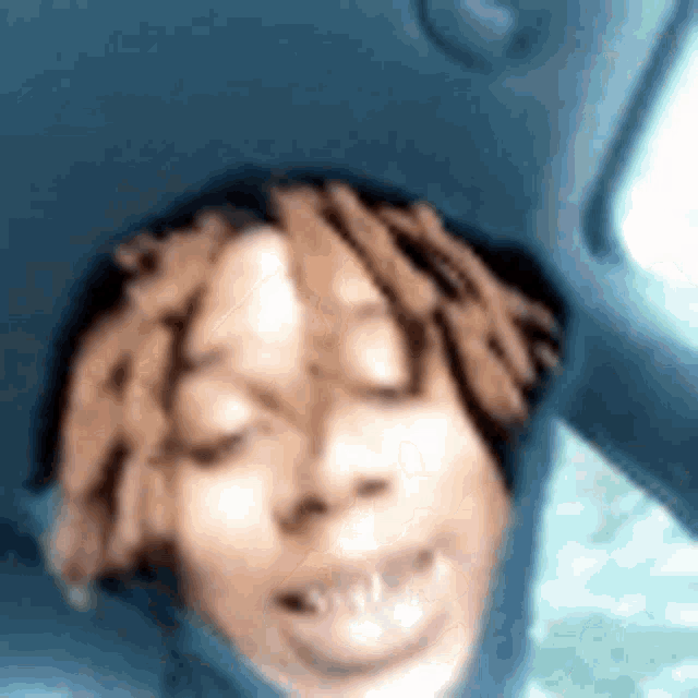 a close up of a person 's face while sitting in a car .