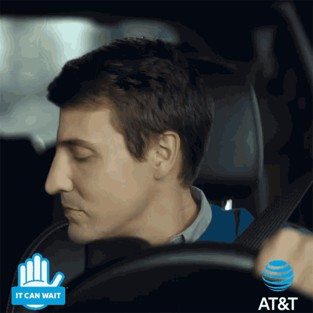 a man in a car with an at & t logo