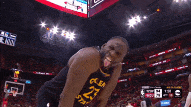 a basketball player wearing a jersey with the number 23 sticking his tongue out