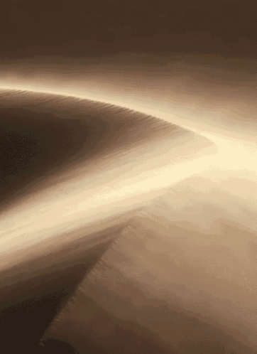 a sand dune in the desert with a light coming out of it .