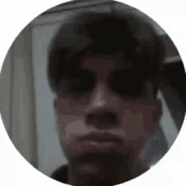 a close up of a man 's face in a circle with a white background .