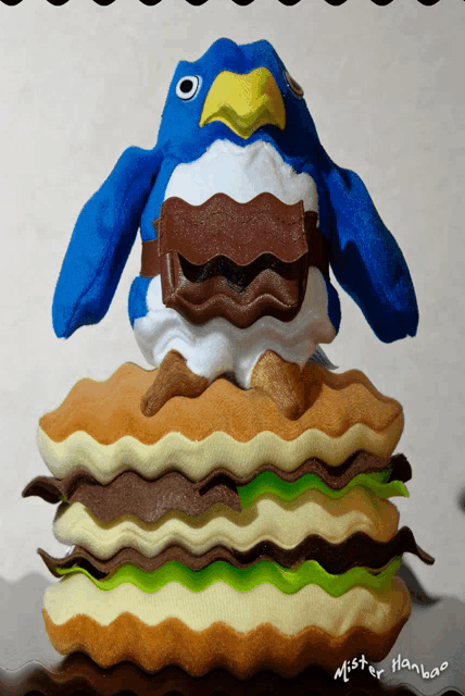 a stuffed penguin sitting on top of a stack of pancakes with mister hanbao written below it