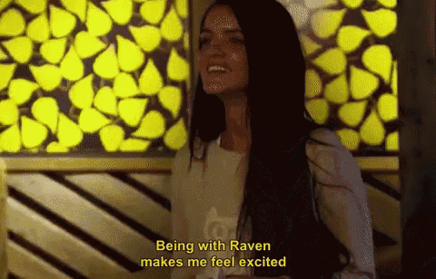 a woman with long hair is standing in front of a yellow wall and says being with raven makes me feel excited
