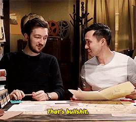 two men are sitting at a desk and one of them is saying that 's bullshit