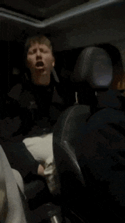 a person is sitting in the back seat of a car with their legs crossed
