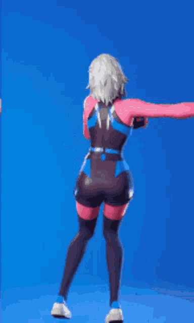 a woman in a pink and blue outfit is standing on a blue surface .
