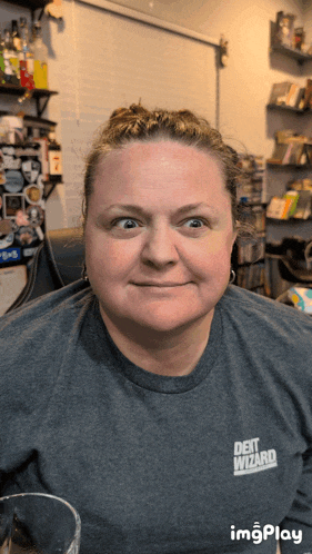 a woman wearing a shirt that says " debt wizard " on it