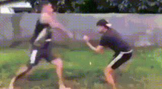 a blurry picture of two men standing next to each other in the grass .