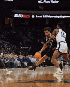 a basketball player with the number 15 on his jersey is dribbling the ball