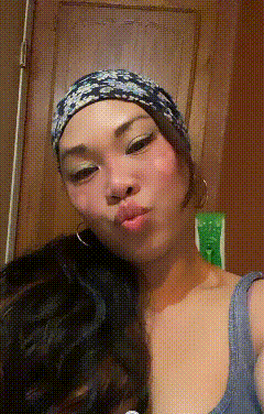 a woman wearing a headband and earrings is making a face
