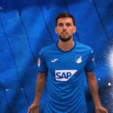 a man wearing a blue shirt with the word sap on the front