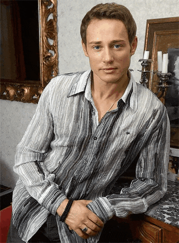 a man in a striped shirt with the letter a on the front