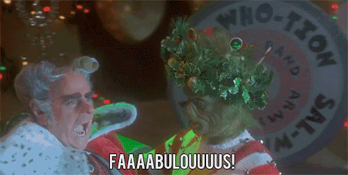 a man in a santa suit is yelling at a grinch who is holding a christmas tree ..