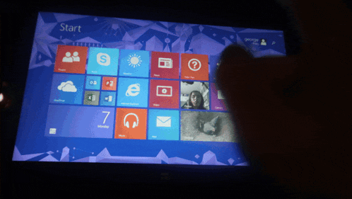a person is using a tablet with a start screen