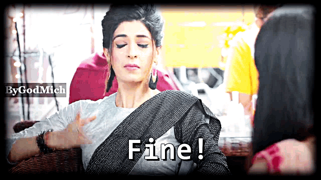 a woman sitting in a chair with the word fine on her chest