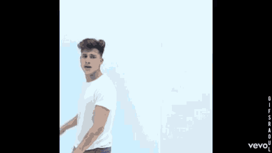 a man in a white t-shirt is making a funny face in a vevo ad