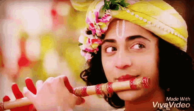 a person playing a flute with the words made with vivavideo on the bottom right
