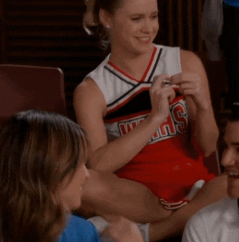 a cheerleader wearing a red and white uniform that says ' angels ' on it