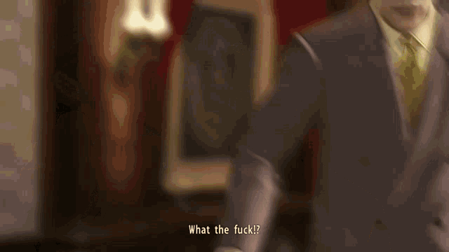 a man in a suit and tie is asking what the fuck