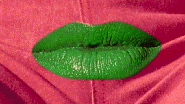 a close up of a woman 's lips with green lipstick
