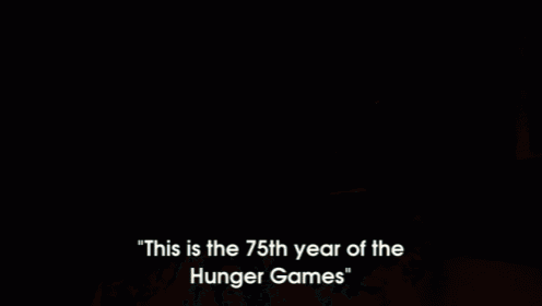 a man is standing in front of a crowd and says this is the 75th year of the hunger games