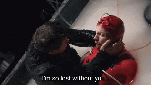 a man in a red wet suit is talking to another man in a bathtub with the words i 'm so lost without you