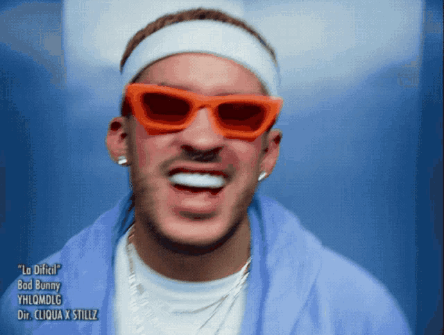 a close up of a man wearing sunglasses and a headband that says bad bunny on it