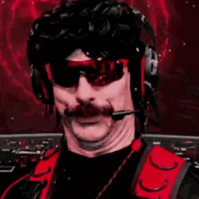 a man with a mustache is wearing headphones and sunglasses .