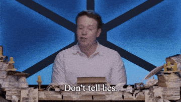 a man sitting in front of a pile of books with the words " don 't tell lies " above him