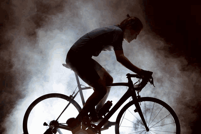 a person is riding a bike in the dark