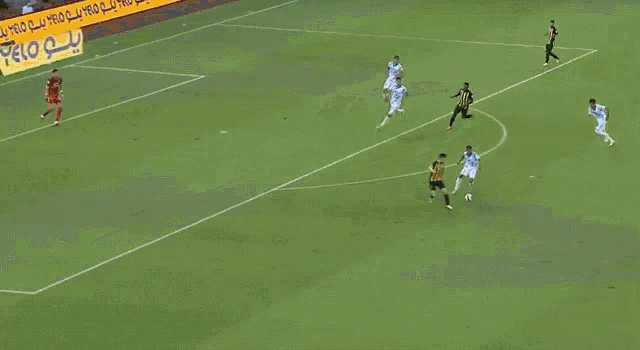 a soccer game is being played on a field with a yellow sign that says velo on it