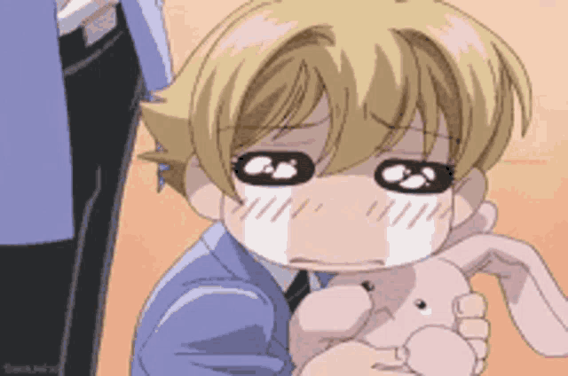 a cartoon character is holding a stuffed animal and crying
