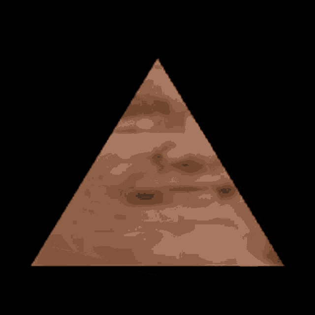 a brown pyramid on a black background with a face in the middle